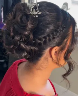 Braided updo with curls and a jeweled hair piece