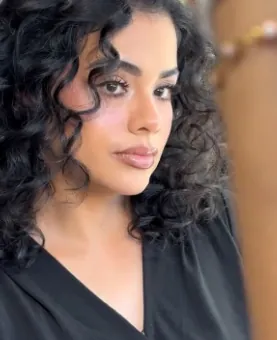 Client with defined curls and full glam makeup