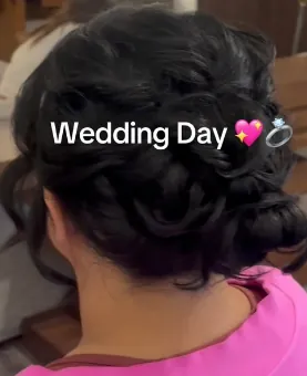 Back view of a sculpted wedding-day low updo