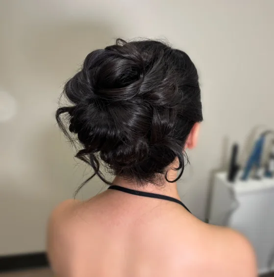 Back view of a textured, voluminous low updo